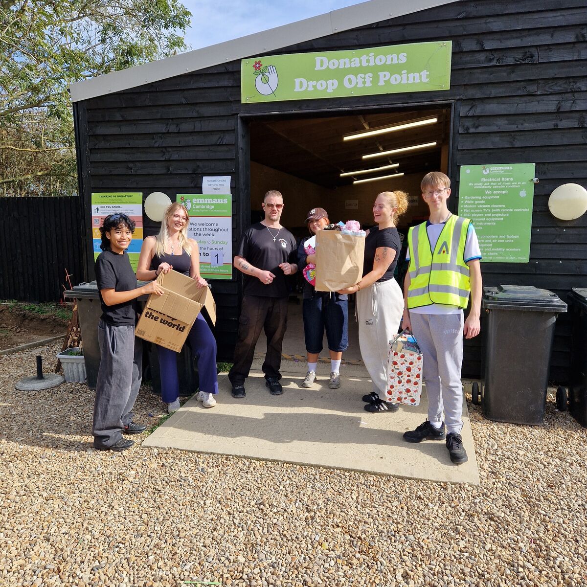 TU Cleaning Service team handing over donations at the Emmaus Cambridge drop-off point